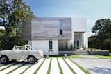 Exterior, Concrete Siding Material, Wood Siding Material, Beach House Building Type, House Building Type, and Flat RoofLine The boxy, contemporary new facade was completely restructured. 

  Photo 8 of 11 in Open Plan by Vidya from Before & After: A Dated Hamptons Home Is Now a Luminous Retreat
