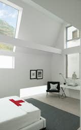 &nbsp;The guest-bedroom suite frames the hillside views above the street, increasing natural light and maintaining privacy.