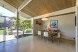 Dining Room, Limestone Floor, Pendant Lighting, Chair, Table, and Table Lighting The dining area looks out over an exterior patio.

  Photos from A Bay Area Eichler With Custom Updates Hits the Market at $1.29M
