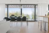 Dining, Pendant, Table, Light Hardwood, Chair, Stools, Rug, and Recessed The dining room table is perfectly positioned to enjoy the sweeping views of the Sörmlands archipelago.  Dining Pendant Rug Stools Photos from Picture Yourself  in This Clifftop Swedish Retreat Asking $1.08M