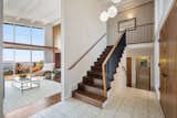 Staircase, Wood Tread, and Wood Railing The split-level home opens to a glimpse of the breathtaking view.  Photo 3 of 14 in A Dreamy Midcentury in Oakland Is Seeking a New Owner For $1.4M