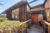 Exterior, House Building Type, Mid-Century Building Type, Wood Siding Material, Shingles Roof Material, and Shed RoofLine The entry of the wood-clad property features beautiful midcentury lines.  Photo 2 of 14 in A Dreamy Midcentury in Oakland Is Seeking a New Owner For $1.4M