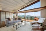 Living, Chair, Dark Hardwood, Table, Sofa, Coffee Tables, Console Tables, and Rug A wall of windows showcases the home's spectacular views of California's South Bay.

  Living Table Coffee Tables Dark Hardwood Photos from A Dreamy Midcentury in Oakland Is Seeking a New Owner For $1.4M