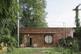 Exterior, Flat RoofLine, Brick Siding Material, and House Building Type Big Space, Little Space preserves the brick exterior.  Photo 1 of 10 in A 1920s Masonry Garage Is Reborn as a Flexible Live/Work Space