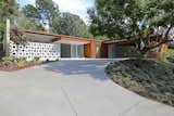 Exterior, Concrete Siding Material, Wood Siding Material, House Building Type, Flat RoofLine, and Mid-Century Building Type The facade features a clean and classic midcentury profile.  Photos from Fifty Shades Actor Jamie Dornan Lists His Midcentury Retreat at $3.2M