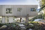 Exterior, Stone Siding Material, Wood Siding Material, Glass Siding Material, Flat RoofLine, Beach House Building Type, and House Building Type The first floor is made up of glass walls that allow the site to appear to remain uninterrupted.   Photo 2 of 11 in A Gorgeous Refuge Treads Lightly on its Surrounding Nature Reserve