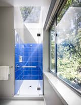 Bath Room, Enclosed Shower, Porcelain Tile Wall, and Porcelain Tile Floor  A bright bathroom is surrounded by tree views.   Photo 8 of 11 in A Gorgeous Refuge Treads Lightly on its Surrounding Nature Reserve