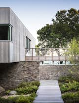 The mix of cedar and stone help integrate the dwelling into its natural setting.