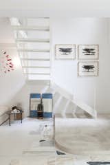 A slim, open-tread staircase contributes to the lightness of the gallery.&nbsp;