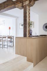 Kitchen, Wood Cabinet, and Wood Counter The kitchen is located a few steps down from the dining room. 

  Photo 4 of 14 in A Parisian Townhouse Is Reborn as a Luminous Art Gallery