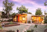 Outdoor, Concrete, Hardscapes, Gardens, Small, Trees, Horizontal, and Back Yard The backyard at dusk.  Outdoor Concrete Small Gardens Photos from An Updated Orange County Eichler Hits the Market at $1M