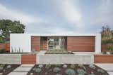 The astonishing transformation post renovation. The exterior palette consists of white stucco and Ipe wood, and the landscaping in the front yard is comprised of drought-tolerant plants, with a focus on succulents. 

