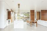 Sliding glass doors have been inserted along the entire width of the kitchen/dining/living room area, enabling the home to be completely open to the elements. The heated cement floors and two indoor fireplaces provide warmth on cooler days. 

