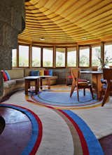 Living Room, Sofa, Chair, Table, and Rug Floor The interiors are a mix of wood, concrete blocks, and custom-designed furniture.  Photo 4 of 13 in The Iconic Home Frank Lloyd Wright Built For His Son Is Listed For $13M