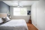 A white ceiling adds visual space to this diminutive bedroom, while a matching white ceiling fan and light fixture complete the look.&nbsp; &nbsp;