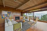 Living, Floor, Sofa, Medium Hardwood, Chair, Standard Layout, Coffee Tables, Wood Burning, End Tables, and Storage The living room from the other angle.   Living Storage Standard Layout Medium Hardwood Wood Burning Photos from A Berkeley Midcentury With Jaw-Dropping Views Asks $945K