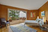 Bedroom, Bed, Night Stands, Medium Hardwood Floor, Table Lighting, and Chair This bedroom has sliding doors leading out the deck.  Photos from A Berkeley Midcentury With Jaw-Dropping Views Asks $945K