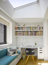 A detail of the office nooks with a teal daybed and built-in shelving. 