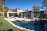 Outdoor, Small, Back Yard, Grass, Wood, Vertical, Retaining, Large, Trees, Horizontal, Shrubs, Hanging, Stone, and Swimming The backyard gives a clear view of the modular construction.   Outdoor Swimming Wood Small Stone Photos from Here Are the Modern Prefab Designs That Amazon’s Investing In