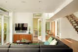 Living Room, Coffee Tables, Sofa, Ottomans, Media Cabinet, Recessed Lighting, and Medium Hardwood Floor Interiors were designed by Kristin Kilmer Design, Inc.  Photo 20 of 21 in Here Are the Modern Prefab Designs That Amazon’s Investing In