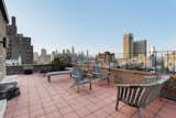 Outdoor, Rooftop, Large Patio, Porch, Deck, Hanging Lighting, Vertical Fences, Wall, Tile Patio, Porch, Deck, Raised Planters, and Metal Fences, Wall The terrace also features killer New York City views.   Photo 3 of 12 in Björk Puts Her Brooklyn Heights Penthouse on the Market For $9M