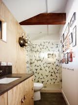 An exposed beam adds depth and character to one of the guest bathrooms while graphic tiles echo the complex geometries of an extensive collection of butterflies that is on display.&nbsp; Joe Fletcher