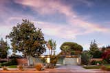 Exterior, Wood Siding Material, Flat RoofLine, Brick Siding Material, Mid-Century Building Type, Glass Siding Material, House Building Type, and Metal Roof Material The flattop Eichler at dusk.  Photo 19 of 19 in An Updated Eichler With an Indoor-Outdoor Master Bath Seeks $1.15M