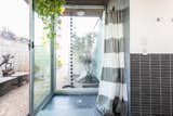 Bath Room, Porcelain Tile Wall, Open Shower, Ceiling Lighting, Porcelain Tile Floor, and Full Shower The indoor-outdoor shower.  Photo 15 of 19 in An Updated Eichler With an Indoor-Outdoor Master Bath Seeks $1.15M