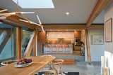 A skylight was added over the dining table to further increase the amount of natural lighting. A bridge between new and old was created by using the timber from a beam that was removed where the kitchen opens to the dining area. 