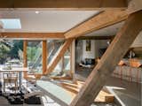 Dining Room, Chair, Recessed Lighting, Table, Terrazzo Floor, and Rug Floor Bright and airy, thanks to extensive glazing, the new space embraces the home's original timber framing.   Photos from Before & After: An Expanded Wedge-Shaped Abode Flaunts its Midcentury Roots