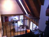Before: a look down at the living room from the second floor.   Photo 15 of 20 in Before & After: An Expanded Wedge-Shaped Abode Flaunts its Midcentury Roots