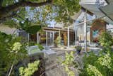 Outdoor, Large, Hardscapes, Gardens, Trees, Front Yard, Pavers, Hanging, and Shrubs Two walls of glass frame the atrium, filling the home with natural light and a strong sense of the outdoors.   Outdoor Front Yard Large Gardens Photos from A Double A-Frame Eichler in the Bay Area Asks $925K