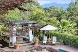 Outdoor, Gardens, Back Yard, Trees, Hardscapes, Large Pools, Tubs, Shower, Shrubs, and Large Patio, Porch, Deck A peek at the poolside cabana. 

  Photos from Robert Redford Is Selling His Napa Valley Retreat For $7.5M