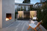 Outdoor, Rooftop, Small, Stone, Concrete, Decking, Trees, Shrubs, Wire, and Horizontal Sweis created a number of different outdoor spaces, each with its own feel.   Outdoor Horizontal Decking Stone Photos from Architect Abeer Sweis Shares Fire-Resistant Building Strategies