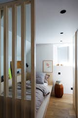 An upstairs bedroom nook. The wood slats help visually integrate the space with the lower level.&nbsp;