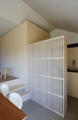 Wood slats divide the space while providing additional storage.&nbsp;
