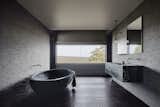 The dramatic, handmade, black concrete soaking tub is from Boyd Alternatives, a local Victorian company that produces handmade baths. The color is an addition to the concrete mix. 