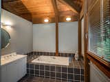 The master bath has two sections—one with a toilet and shower stall, and one with a soaking tub.