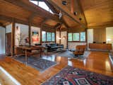 Living Room, Medium Hardwood Floor, Ceiling Lighting, Chair, Sofa, Storage, Console Tables, Lamps, Coffee Tables, and Table Lighting  Photos from A Midcentury-Inspired Post-and-Beam Home Hits the Market in Connecticut For $595K