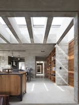 Rectangular skylights help bring natural light into the home, offsetting the heaviness of the concrete volume.