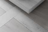 A detail of the light grey brushed oak floors with marble accent lines. 