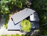 Viewed from above, the home wraps around itself and is folded around a small central courtyard. The roof sections overlap in an organic way, giving the home its name: Four Leaves. 