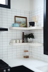 A Petite Cast Iron Fondue Set from Schoolhouse sits on a kitchen shelf.&nbsp;