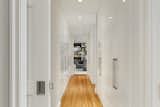 A hallway full of storage space leads to a media room.