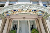 The home's entrance features Tiffany stained glass windows.