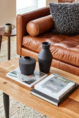 The coffee table is from Farmhaus Modern, and the black stepped planters are from Cone 10.&nbsp;
