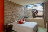 The third bedroom features a groovy stone inlay wall, which carries into the home from the exterior.