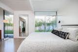 The&nbsp;master bedroom features sliding glass doors leading outdoors.&nbsp;