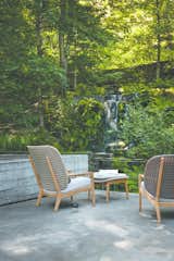 An all-weather wicker-like fiber is used to create the oversized, and dramatically curved French cane backrest which is available in two different sizes. The Kay collection comes in three colorways: Brindle, Harvest or Copper fiber set on the elegant teak frame.