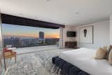 The penthouse-level master suite opens to a balcony with sweeping city views.